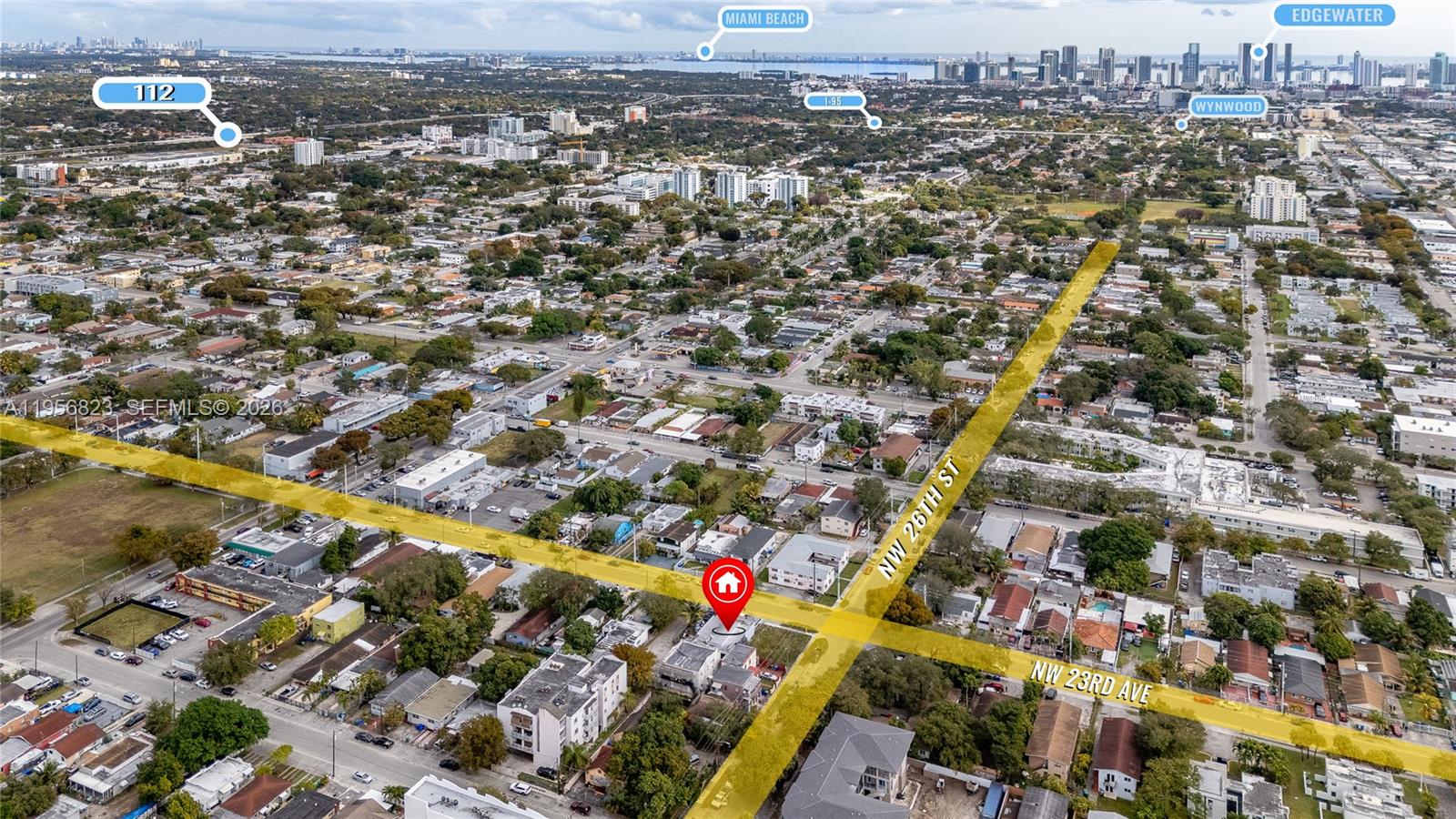 This aerial view shows a residential property highlighted at a street intersection in a city — 2610 NW 23rd Ave, Miami FL 33142, MIAMI, FL