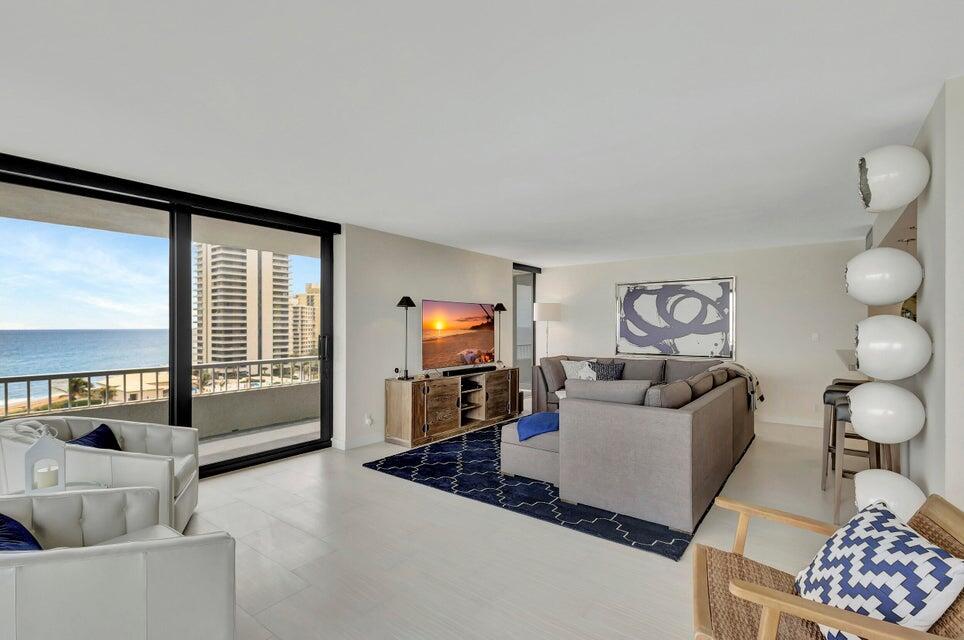 A living room with a sectional sofa, blue area rug, and a balcony overlooking the ocean — 5550 N Ocean Drive # 8a, Singer Island FL 33404, SINGER ISLAND, FL