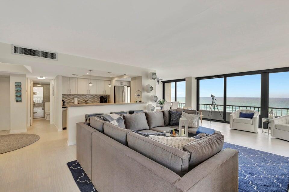 A living room and kitchen area with a large gray sectional sofa and ocean views — 5550 N Ocean Drive # 8a, Singer Island FL 33404, SINGER ISLAND, FL