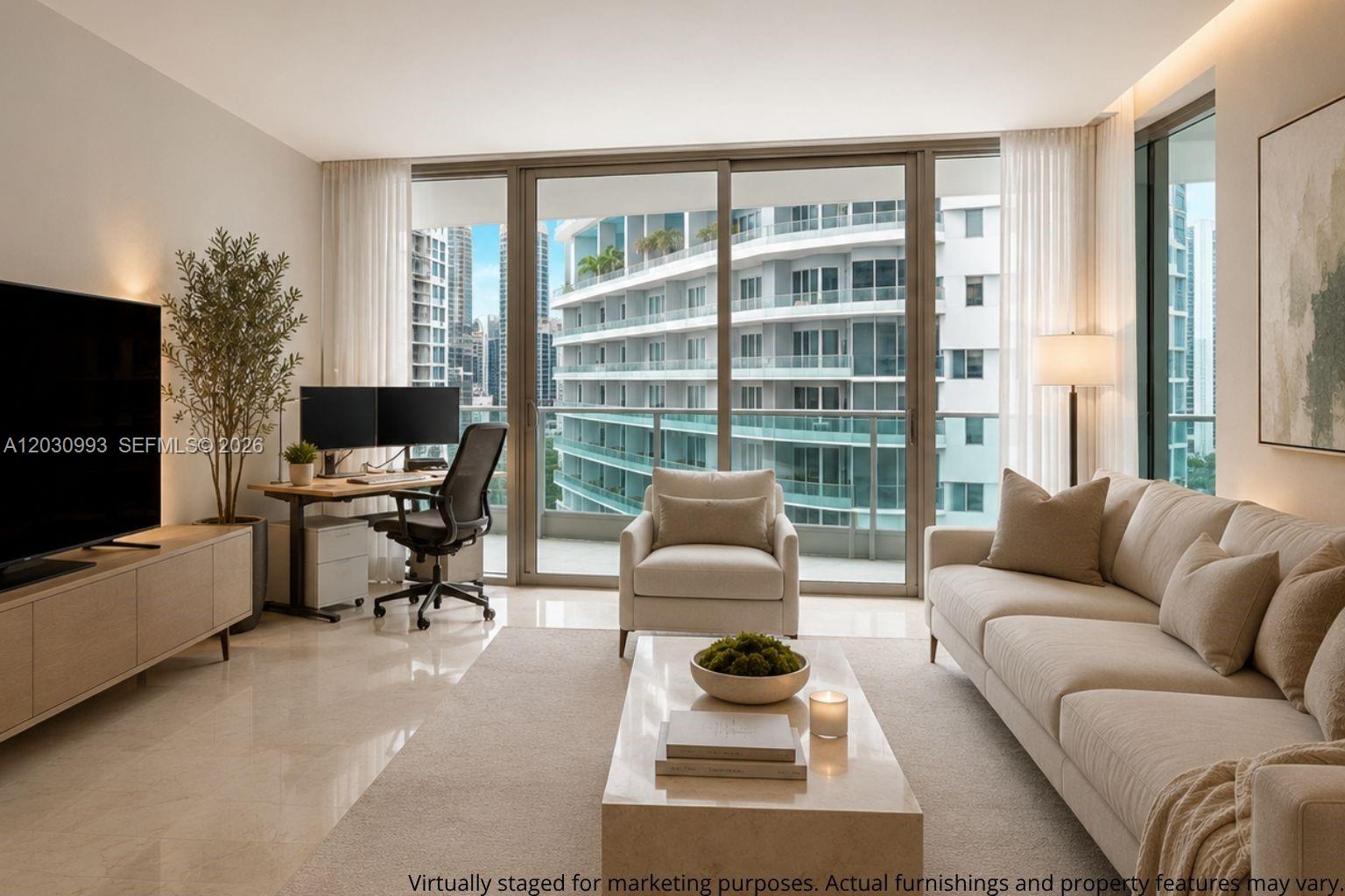 A living room with a desk, sofa, and floor-to-ceiling windows overlooking a neighboring building — 1331 BRICKELL BAY DR # 1004, Miami FL 33131, MIAMI, FL