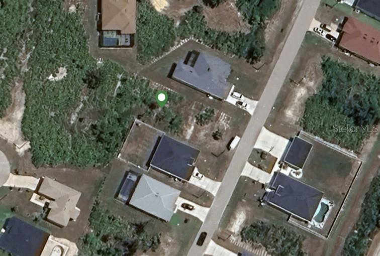 This aerial view shows a vacant residential lot marked with a pin near existing houses — 341 BAYTREE DRIVE, ROTONDA WEST, FL