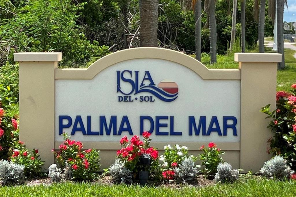 A sign for Isla del Sol Palma del Mar stands in a landscaped garden area — 6322 PALMA DEL MAR BLVD S UNIT 103, ST PETERSBURG, FL