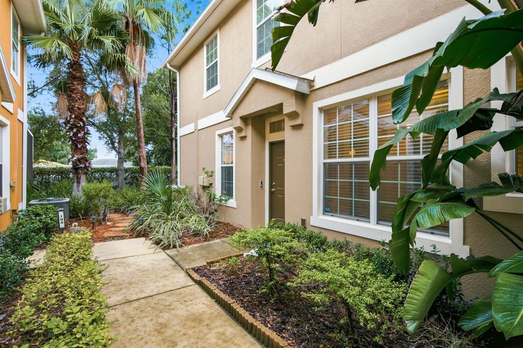 An open-concept living area features hardwood floors, a ceiling fan, and sliding glass patio doors — 7001 INTERBAY BOULEVARD UNIT 192, TAMPA, FL