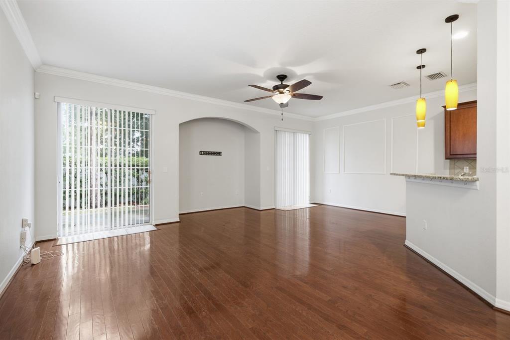 A kitchen features dark wood cabinets, granite countertops, stainless steel appliances, and light tile flooring — 7001 INTERBAY BOULEVARD UNIT 192, TAMPA, FL