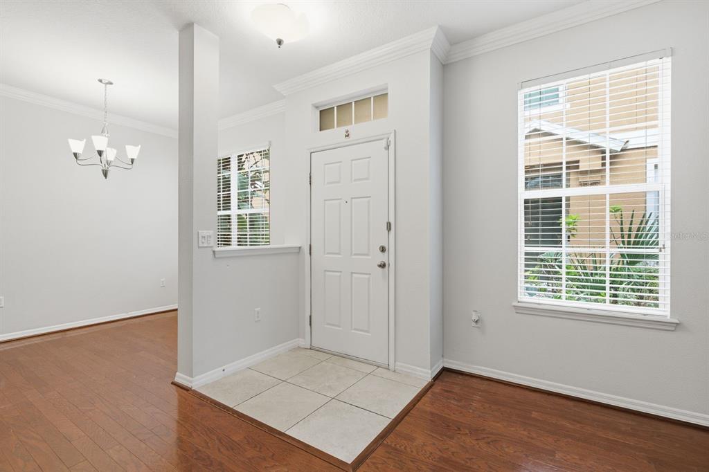 A kitchen with wood cabinets, granite countertops, stainless steel appliances, and tile flooring — 7001 INTERBAY BOULEVARD UNIT 192, TAMPA, FL