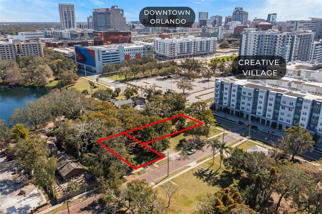 An aerial view shows a vacant, tree-covered lot outlined in red near urban buildings — 623 W CONCORD STREET, ORLANDO, FL
