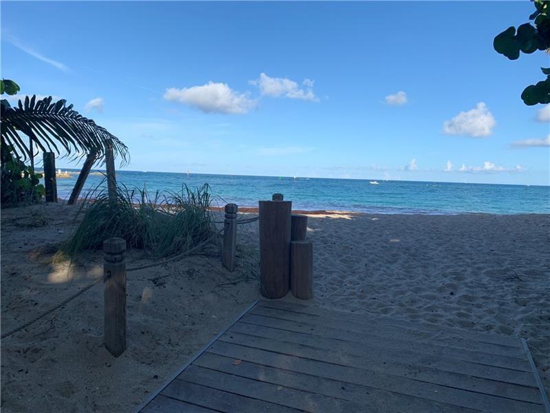 A wooden walkway leads through sand toward a beach with ocean views and blue skies — 3421 Dover Road, Pompano Beach FL 33062, POMPANO BEACH, FL