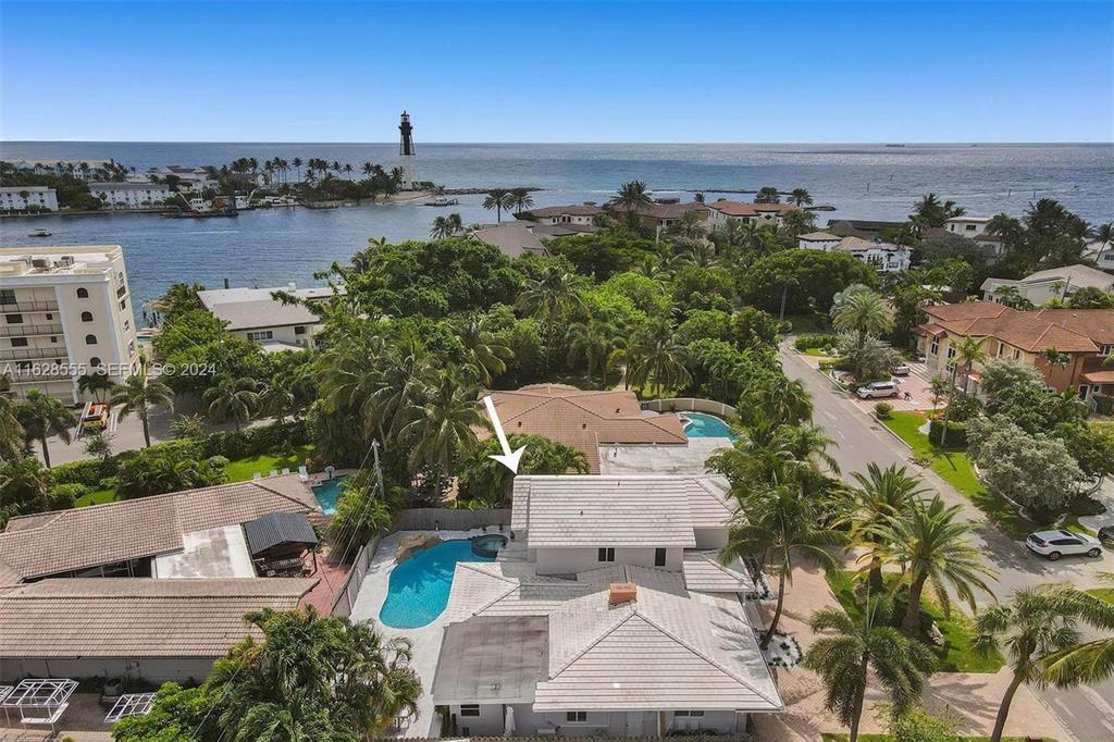 An aerial view shows a house with a swimming pool near a coastal lighthouse — 3421 Dover Road, Pompano Beach FL 33062, POMPANO BEACH, FL