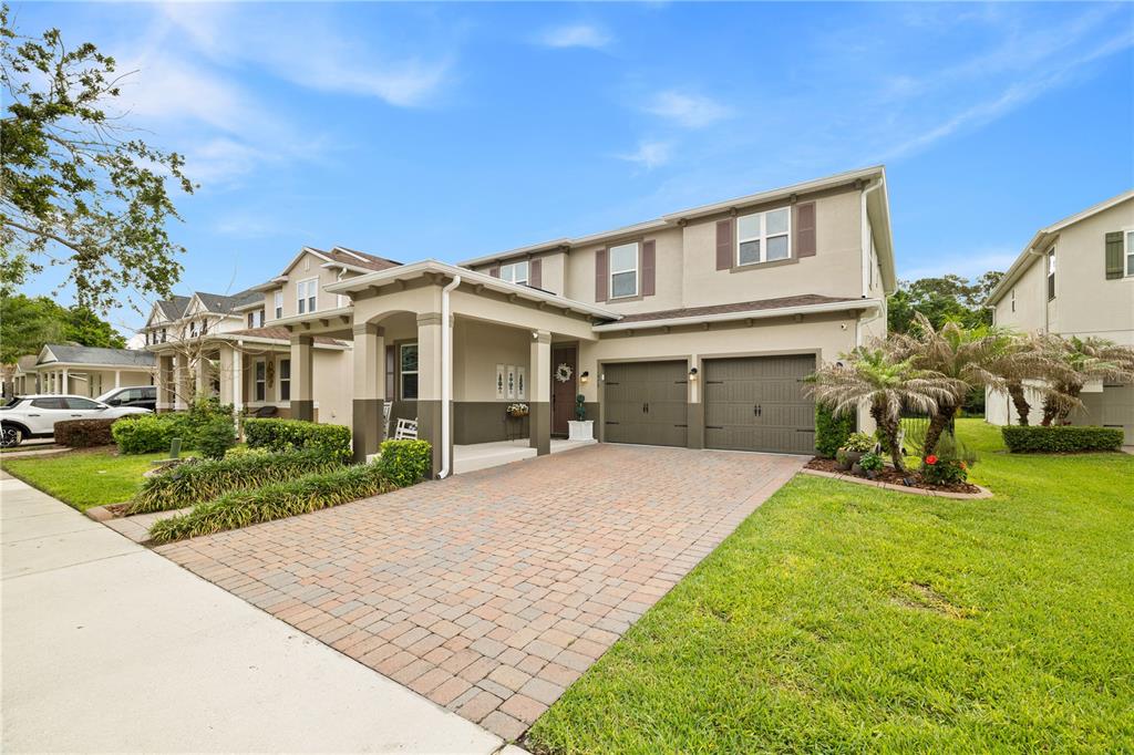 A two-story suburban house with a paved driveway, two-car garage, and a covered front porch — 11478 WAKEWORTH STREET, ORLANDO, FL