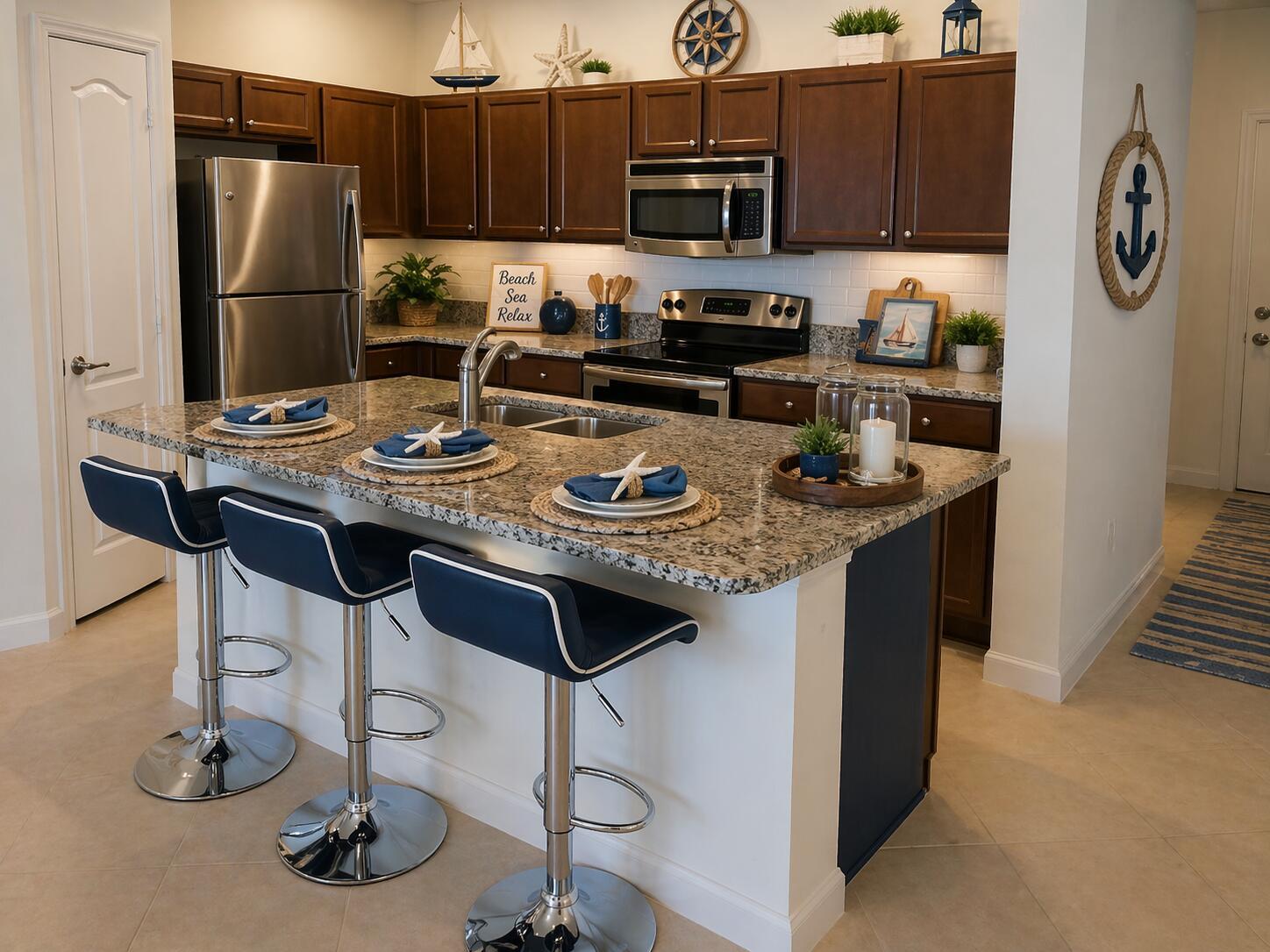 A kitchen features dark wood cabinets, granite countertops, a central island, and nautical-themed decor — 9503 SW Merlin Court, Stuart FL 34997, STUART, FL