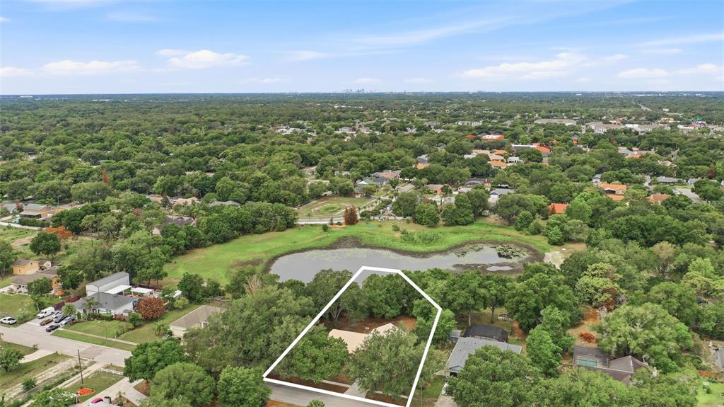 An aerial view shows a house with a white outline on a lot near a pond — 3286 LAKE TWYLO ROAD, ORLANDO, FL