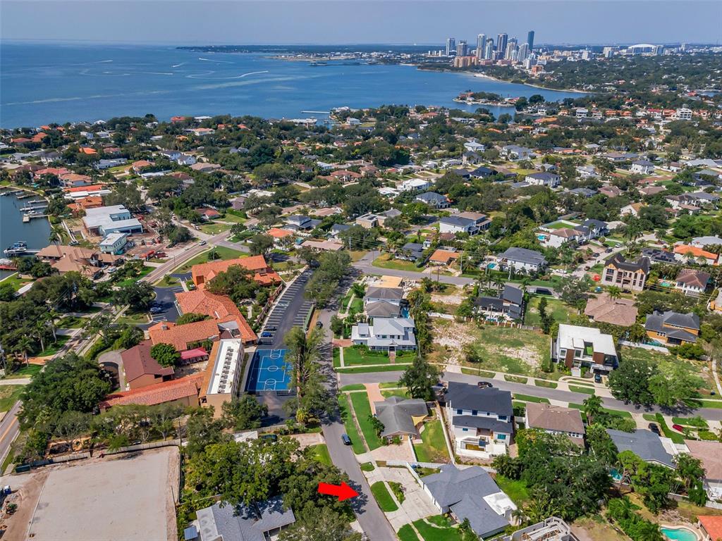 Aerial view of a residential neighborhood near the water with a red arrow pointing down — 850 RAFAEL BOULEVARD NE, ST PETERSBURG, FL
