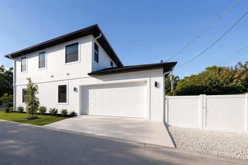 A white two-story house with a black roof and an attached two-car garage — 2925 13TH STREET N, ST PETERSBURG, FL