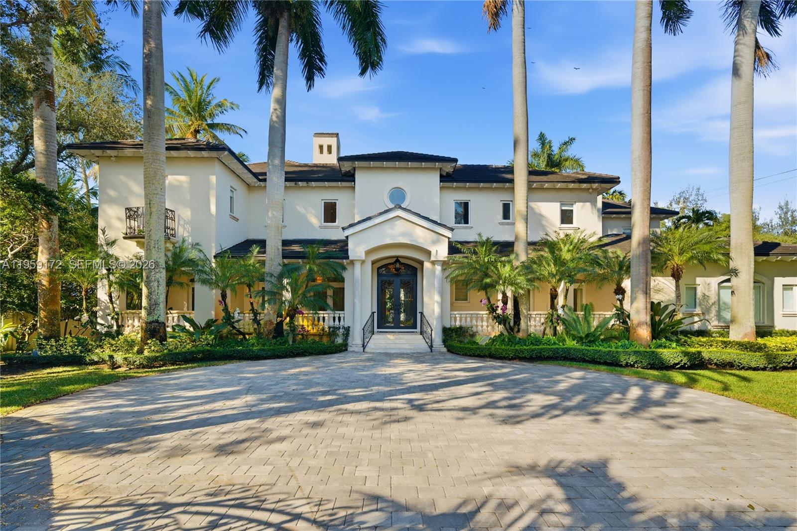 A large two-story Mediterranean-style house features a paved driveway, palm trees, and a grand entrance — 8400 SW 52nd Ave, Miami FL 33143, MIAMI, FL