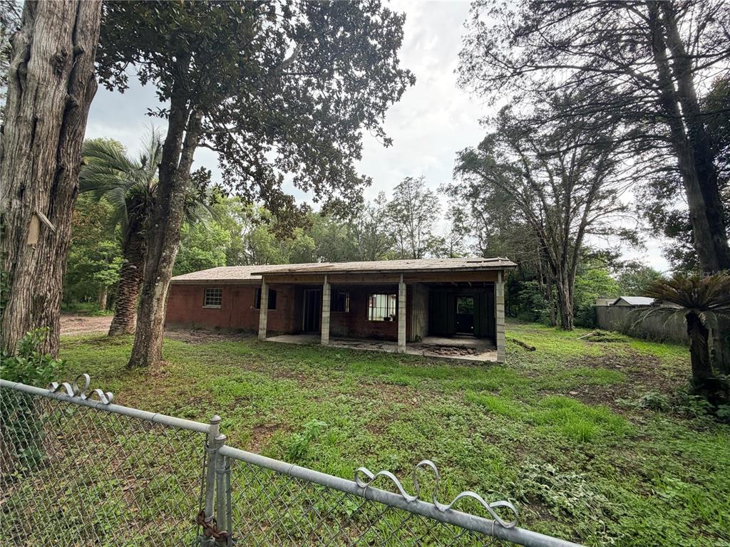 A single-story house with an unfinished concrete block section and a green painted wall — 343 LINCOLN AVENUE, BROOKSVILLE, FL