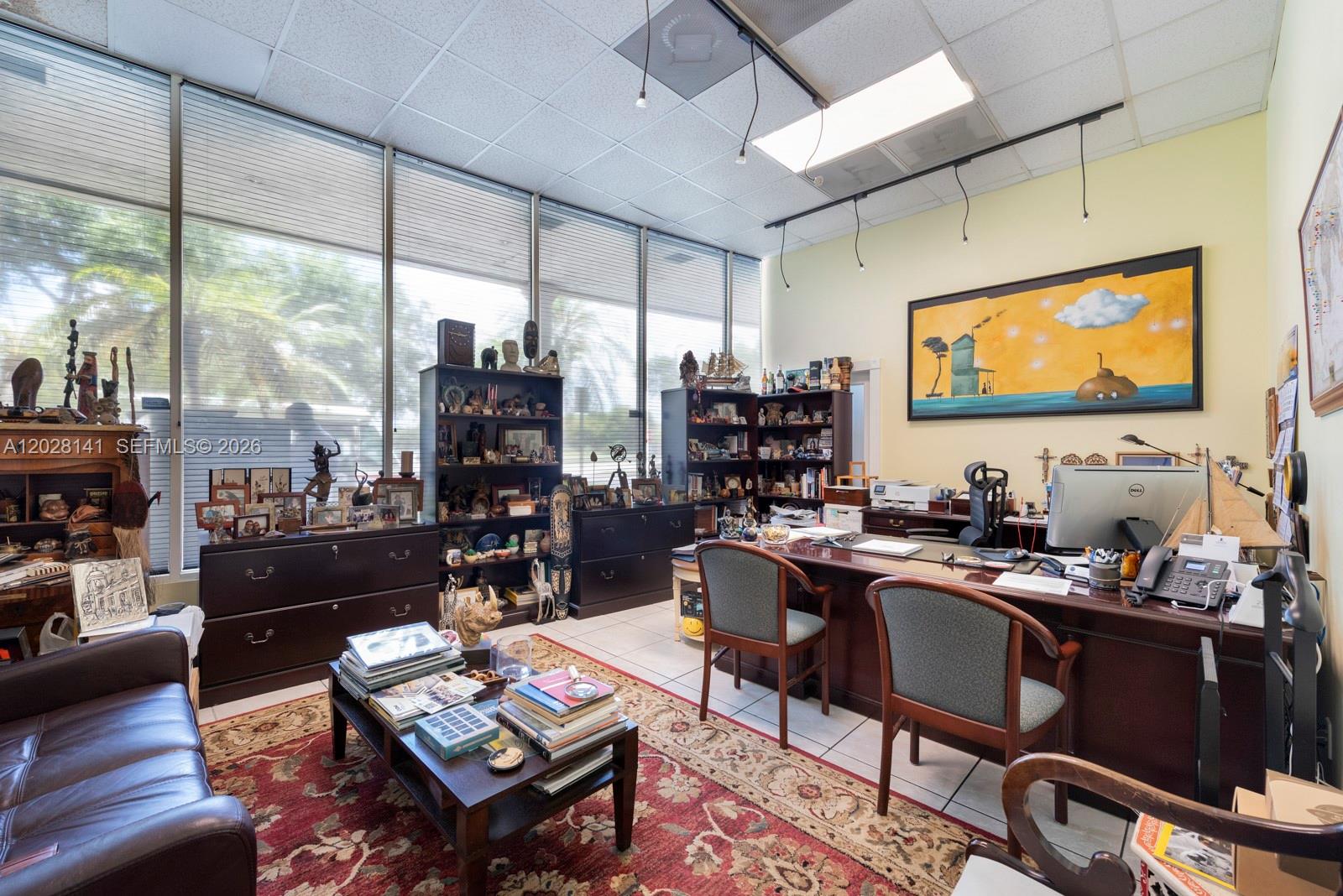An office features a large desk, bookshelves, a coffee table, and a leather sofa — 10200 NW 25th St # A105, Doral FL 33172, DORAL, FL