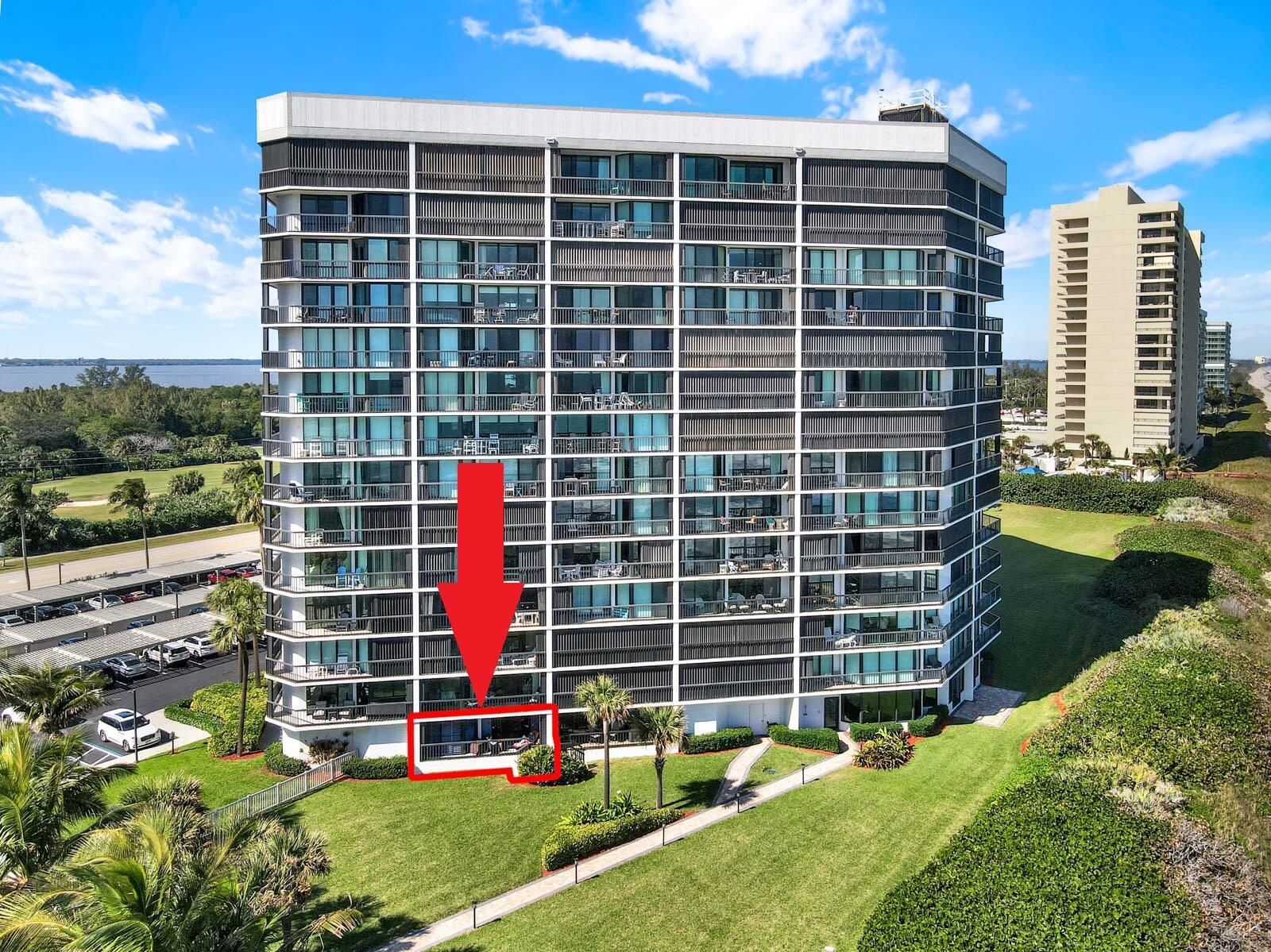 An aerial view of a multi-story residential building with a red arrow pointing to a patio — 8800 S Ocean Drive # 109, Jensen Beach FL 34957, JENSEN BEACH, FL
