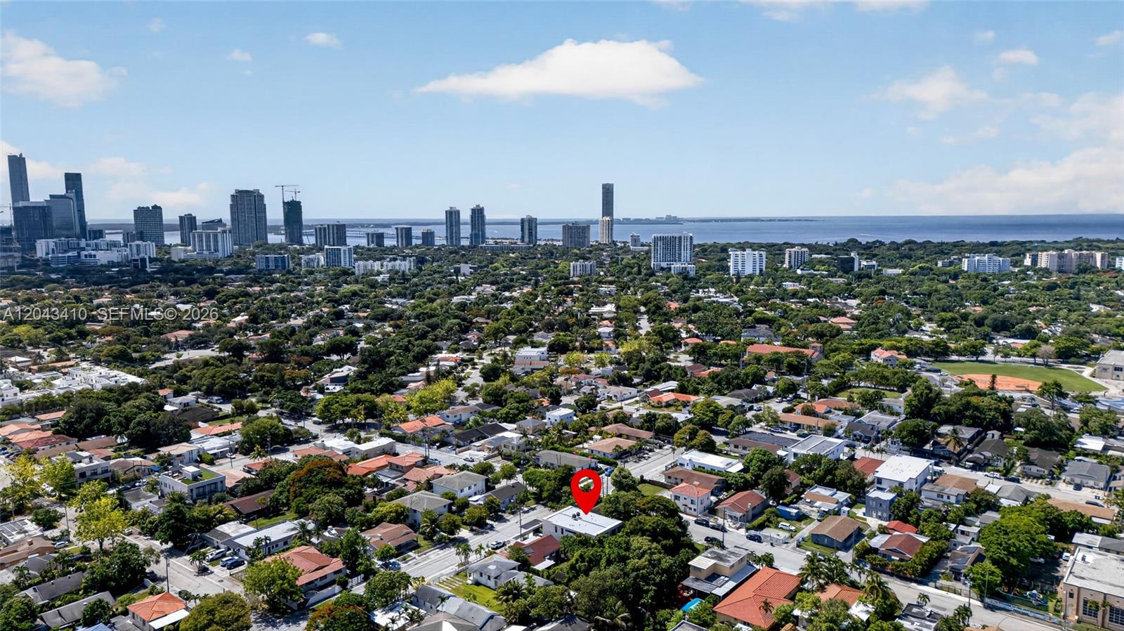 An aerial view shows a residential neighborhood with a red pin marking a specific house — 1032 SW 11th Ave, Miami FL 33130, MIAMI, FL