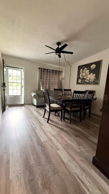 A dining room with wood-look flooring, a dark wood table, and a ceiling fan — 4810 DEAUVILLE DRIVE, ORLANDO, FL