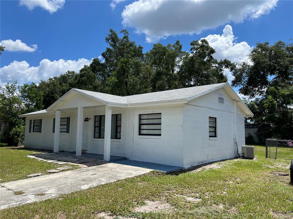 A white, single-story house with a covered front porch and a concrete driveway — 605 PLUM LANE, ALTAMONTE SPRINGS, FL