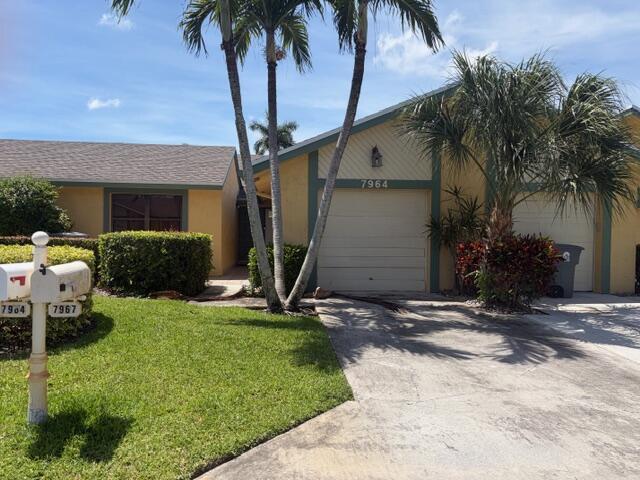 A yellow one-story house with a garage, palm trees, and two mailboxes in the front — 7964 Little Lane, Boca Raton FL 33433, BOCA RATON, FL