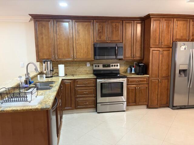 A kitchen with wood cabinets, stainless steel appliances, and granite countertops — 7964 Little Lane, Boca Raton FL 33433, BOCA RATON, FL