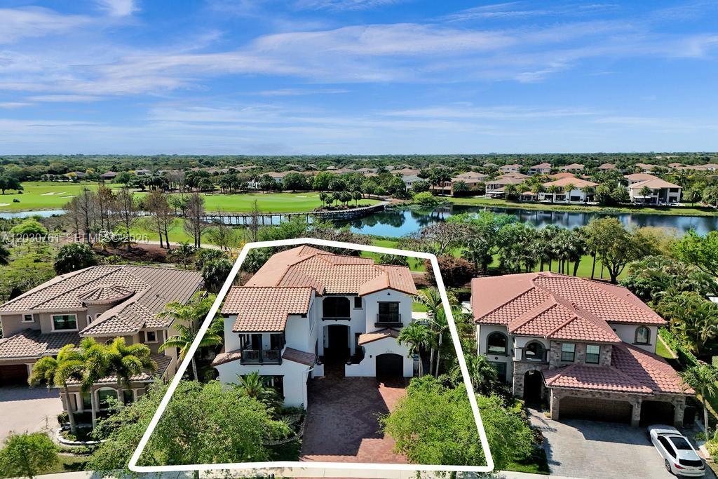 An aerial view shows a two-story house with a tile roof and a paved driveway — 10292 Emerson St, Parkland FL 33076, PARKLAND, FL