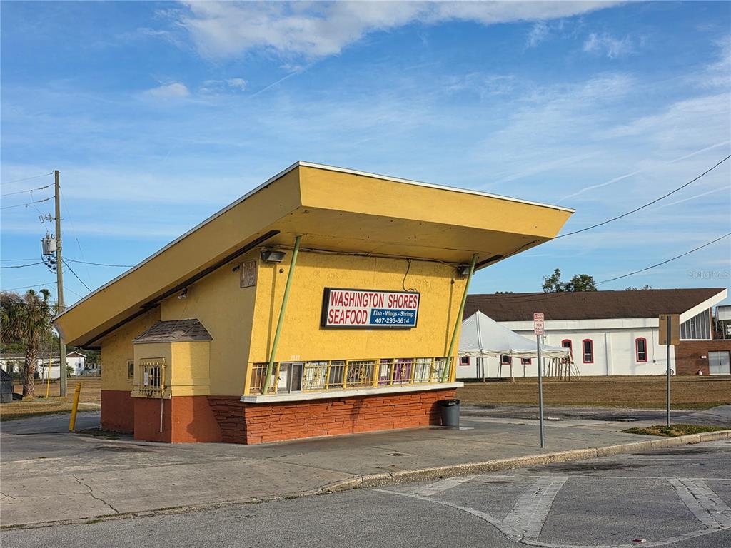 A yellow, mid-century modern style building with a large, slanted roof overhang — 3625 COLUMBIA STREET, ORLANDO, FL