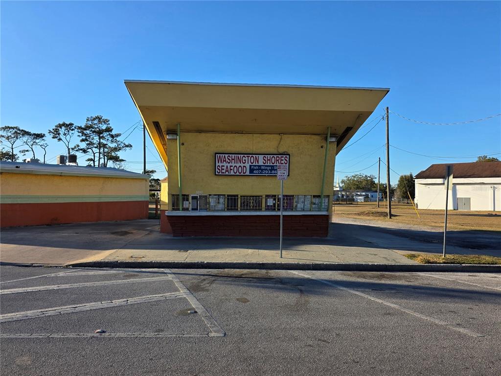 A yellow, mid-century style commercial building with a large overhang and a seafood restaurant sign — 3625 COLUMBIA STREET, ORLANDO, FL