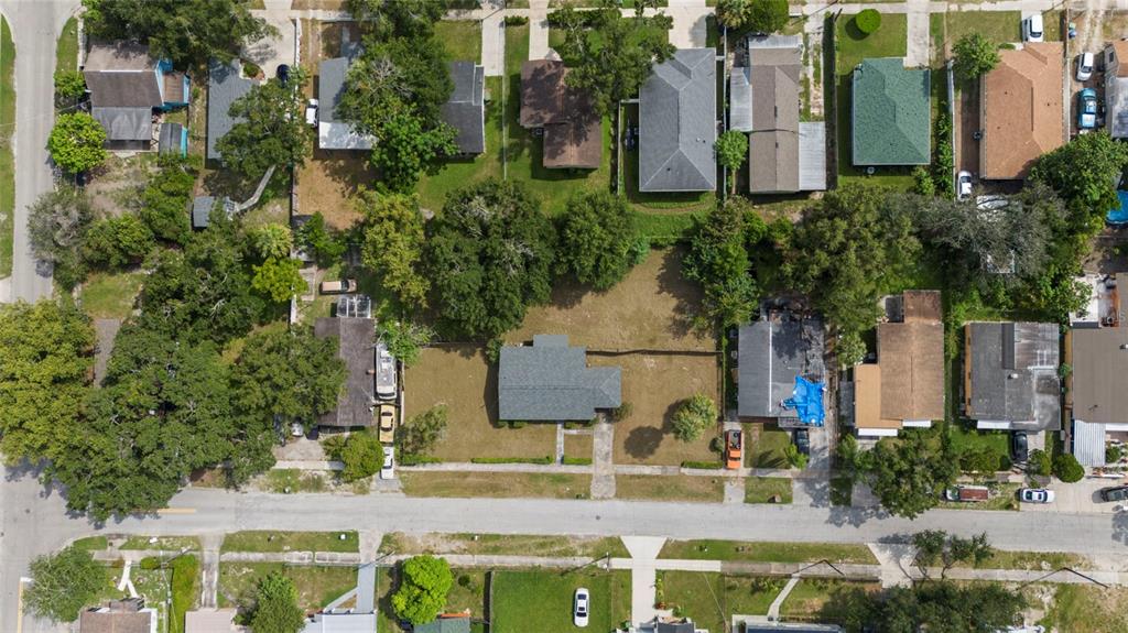 An aerial view shows a residential neighborhood with houses, trees, and a street — 3415 DELEUIL AVENUE, TAMPA, FL