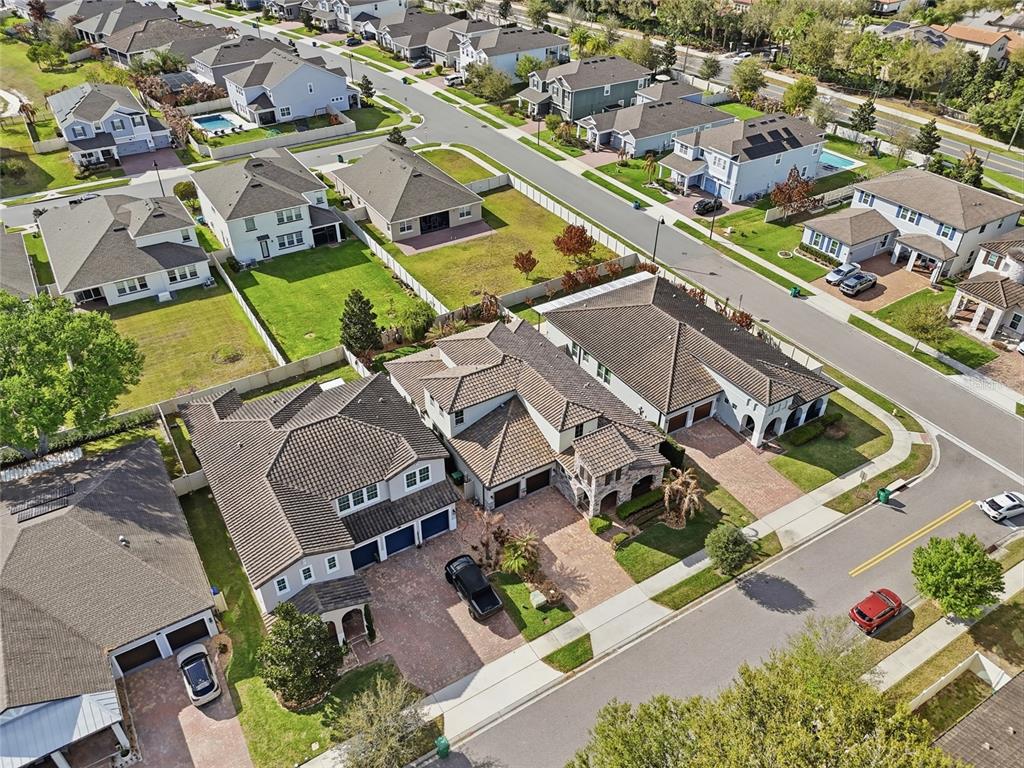 An aerial view shows several suburban houses with tiled roofs and paved driveways — 1646 HOLCOMB CREEK STREET, WINTER GARDEN, FL