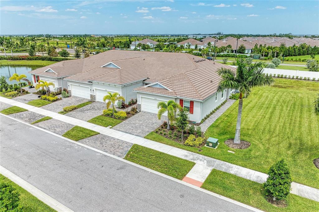 An aerial view of a single-story duplex with a tiled roof and paved driveways — 12574 SOMATIC COURT, VENICE, FL