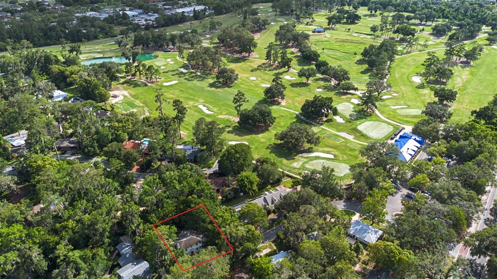 An aerial view shows a house outlined in red, situated near a large golf course — 2721 SW 3RD PLACE, GAINESVILLE, FL