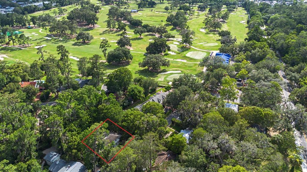 An aerial view shows a house outlined in red, situated near a large golf course — 2721 SW 3RD PLACE, GAINESVILLE, FL