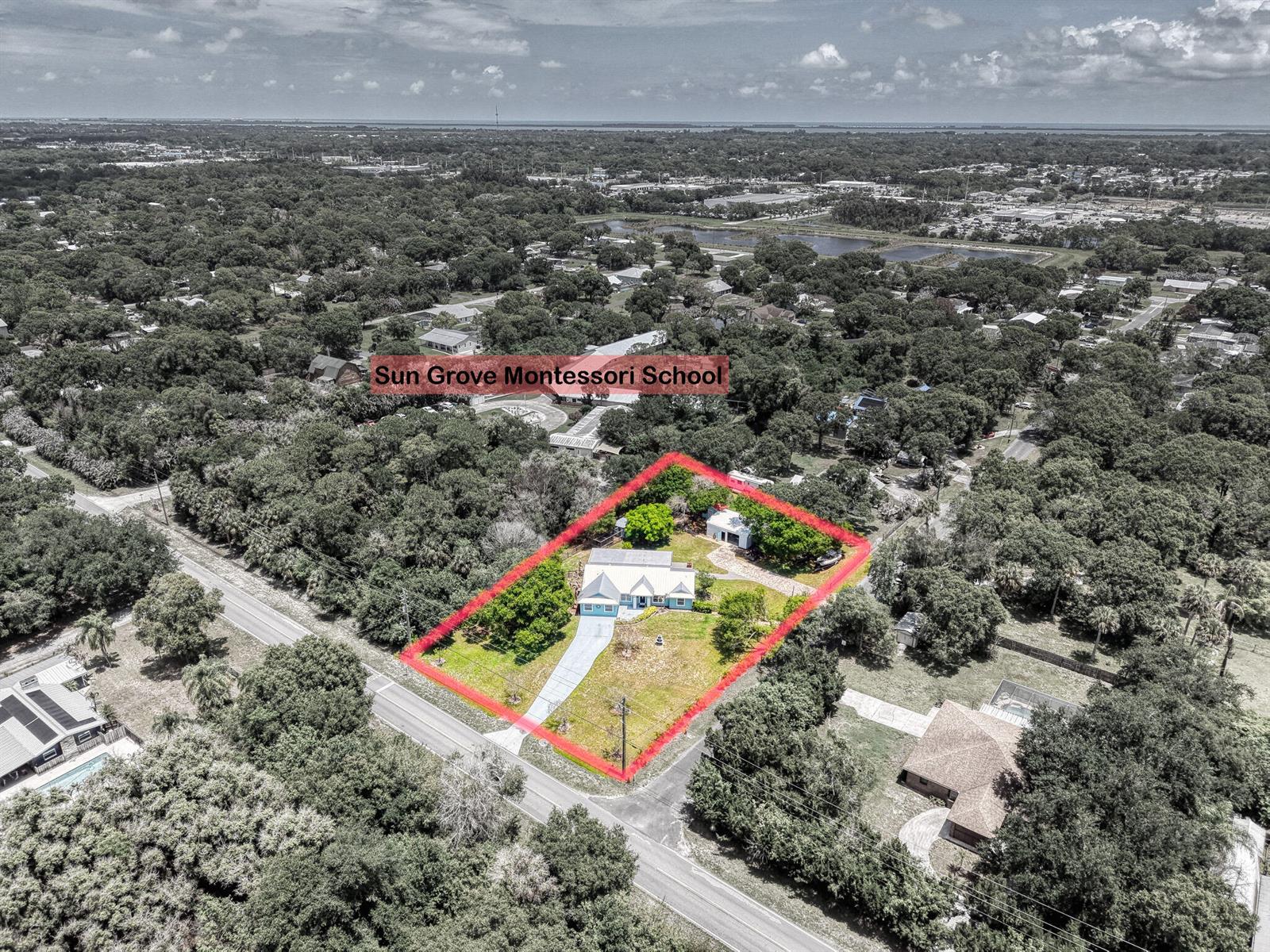An aerial view shows a house with a red boundary line on a wooded lot — 5700 Oleander Avenue, Fort Pierce FL 34982, FORT PIERCE, FL