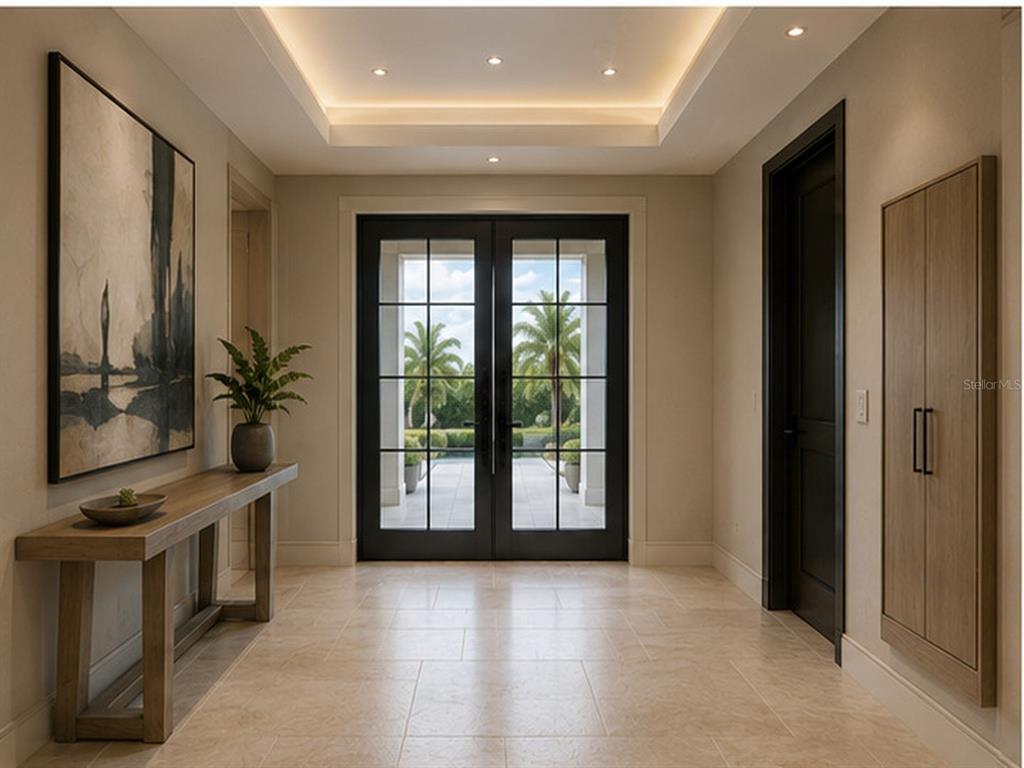 A foyer features a tray ceiling, tile flooring, a console table, and double glass entry doors — 15140 INGRAHAM BOULEVARD, PORT CHARLOTTE, FL
