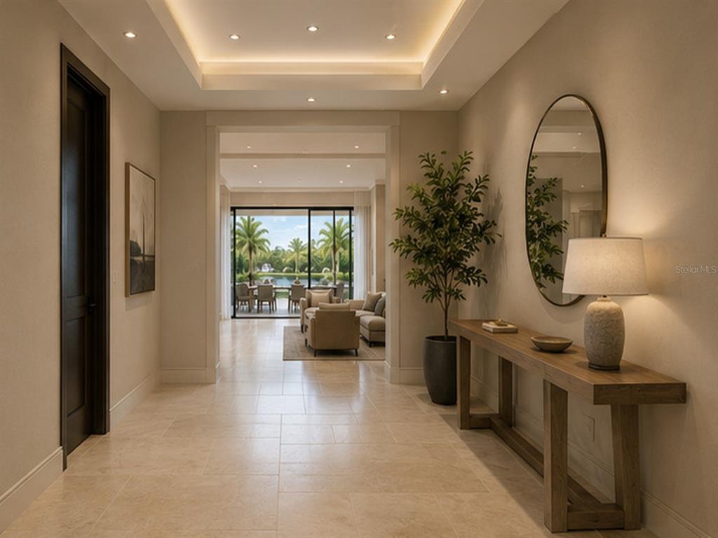 A bright foyer features a console table, a mirror, and a view into a living area — 15140 INGRAHAM BOULEVARD, PORT CHARLOTTE, FL