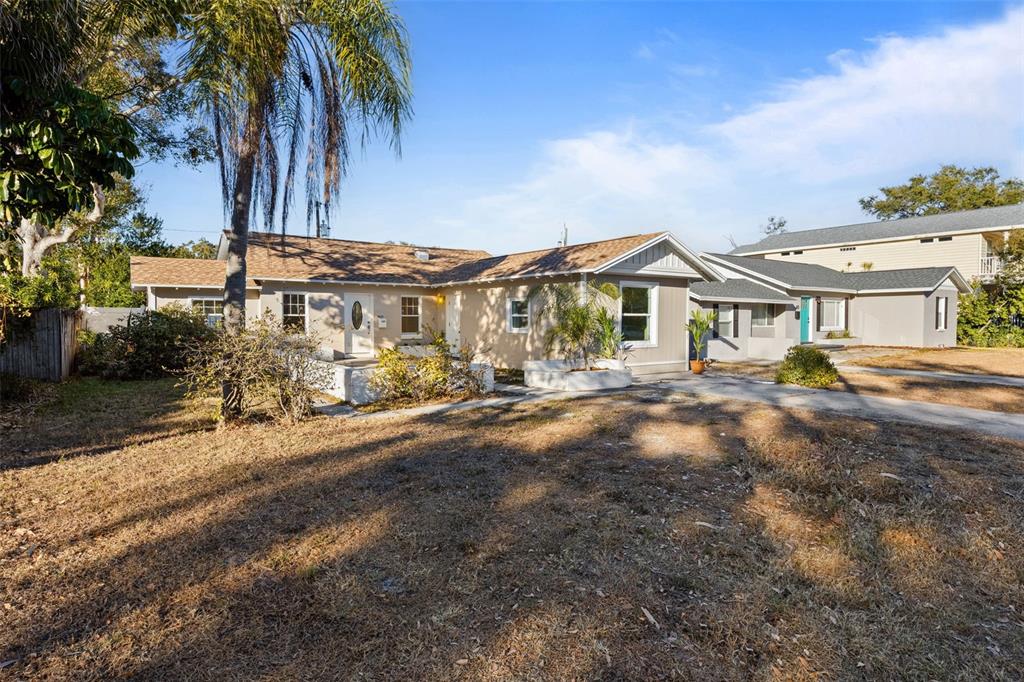 A single-story house with a tan exterior, brown roof, and a palm tree in front — 3821 6TH AVENUE N, ST PETERSBURG, FL