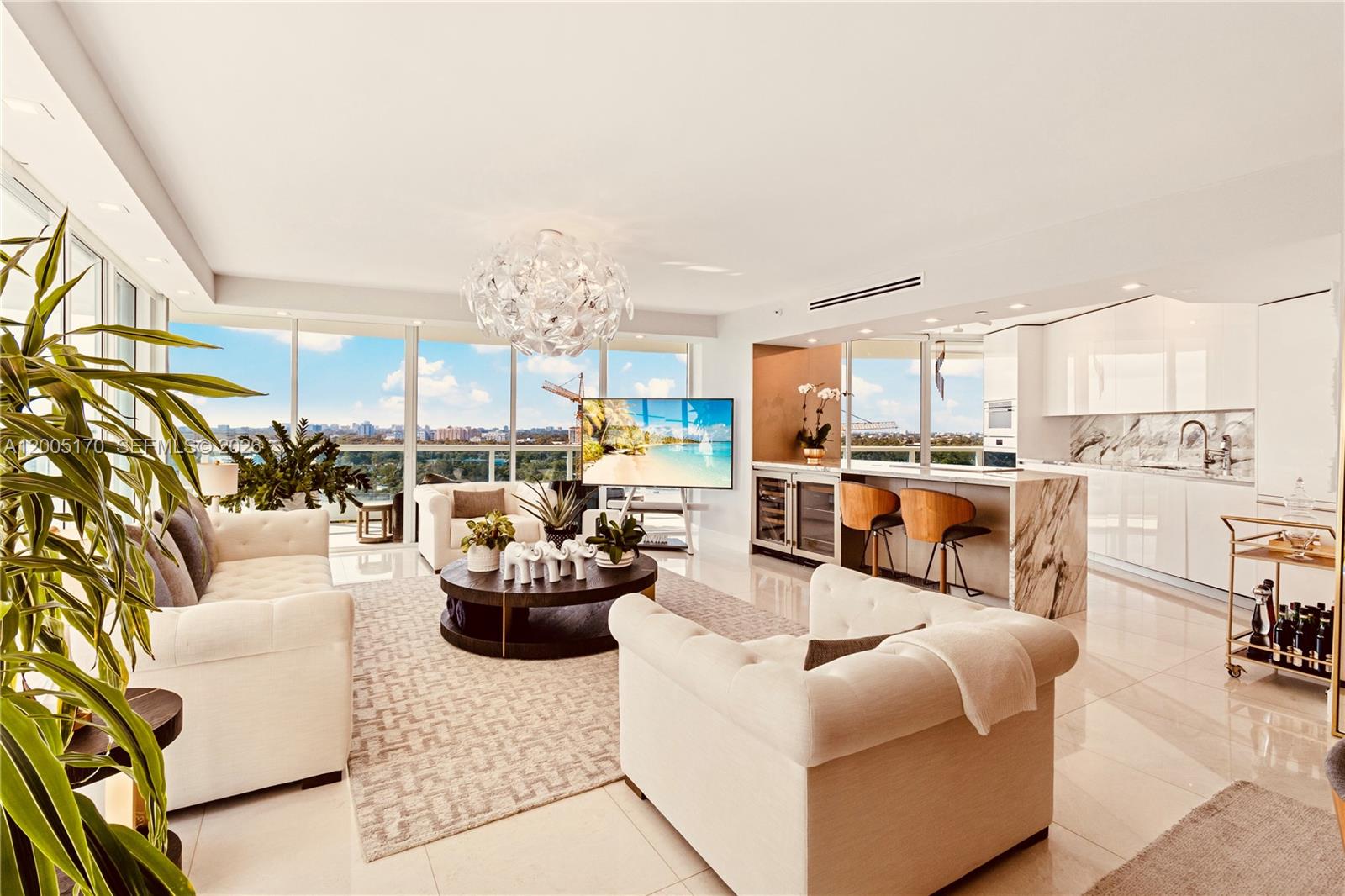 A bright, open-concept living room and kitchen area features floor-to-ceiling windows with city views — 2127 Brickell Ave # 1505, Miami FL 33129, MIAMI, FL