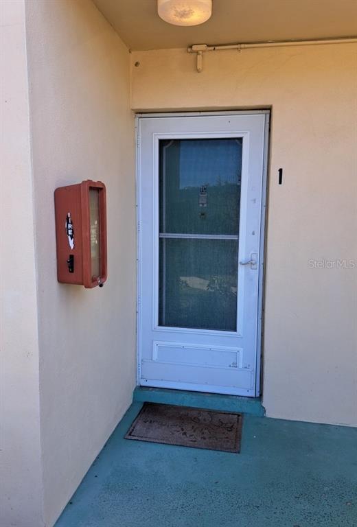 A white storm door with the number one on the wall next to a fire box — 2005 GREENBRIAR BOULEVARD UNIT 1, CLEARWATER, FL