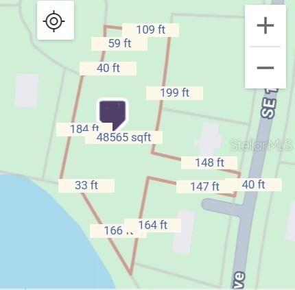 A view of a wooded lot situated behind a pond covered in lily pads — 2650 SE 179TH AVENUE, SILVER SPRINGS, FL
