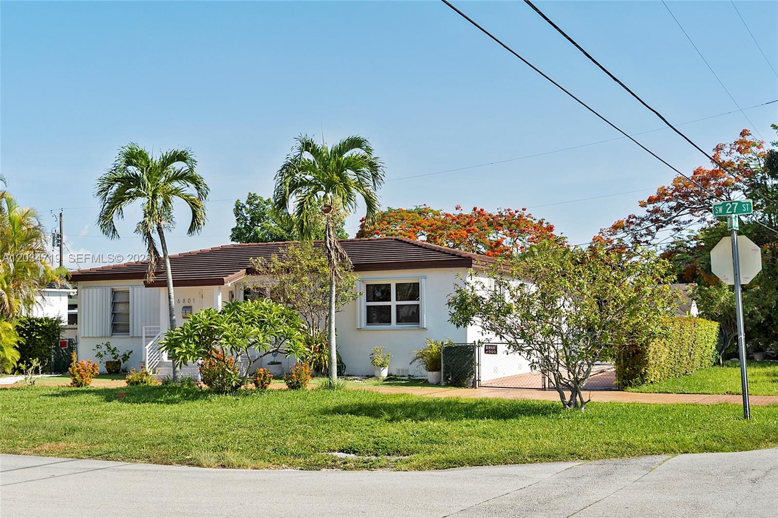 A single-story white house with a brown roof, palm trees, and a front lawn — 6801 SW 27th St, Miami FL 33155, MIAMI, FL
