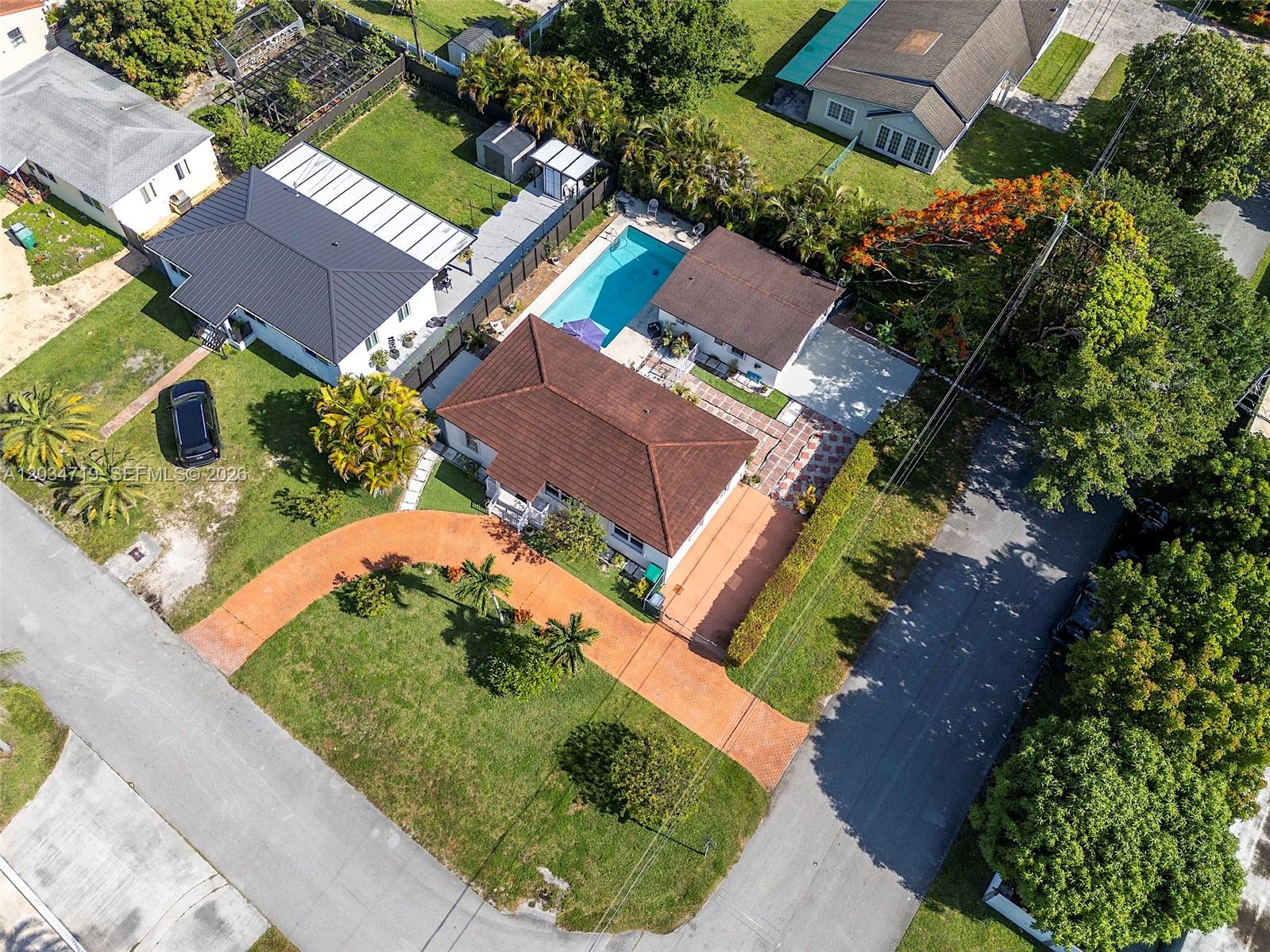 An aerial view shows a residential property with a brown roof, pool, and paved driveway — 6801 SW 27th St, Miami FL 33155, MIAMI, FL