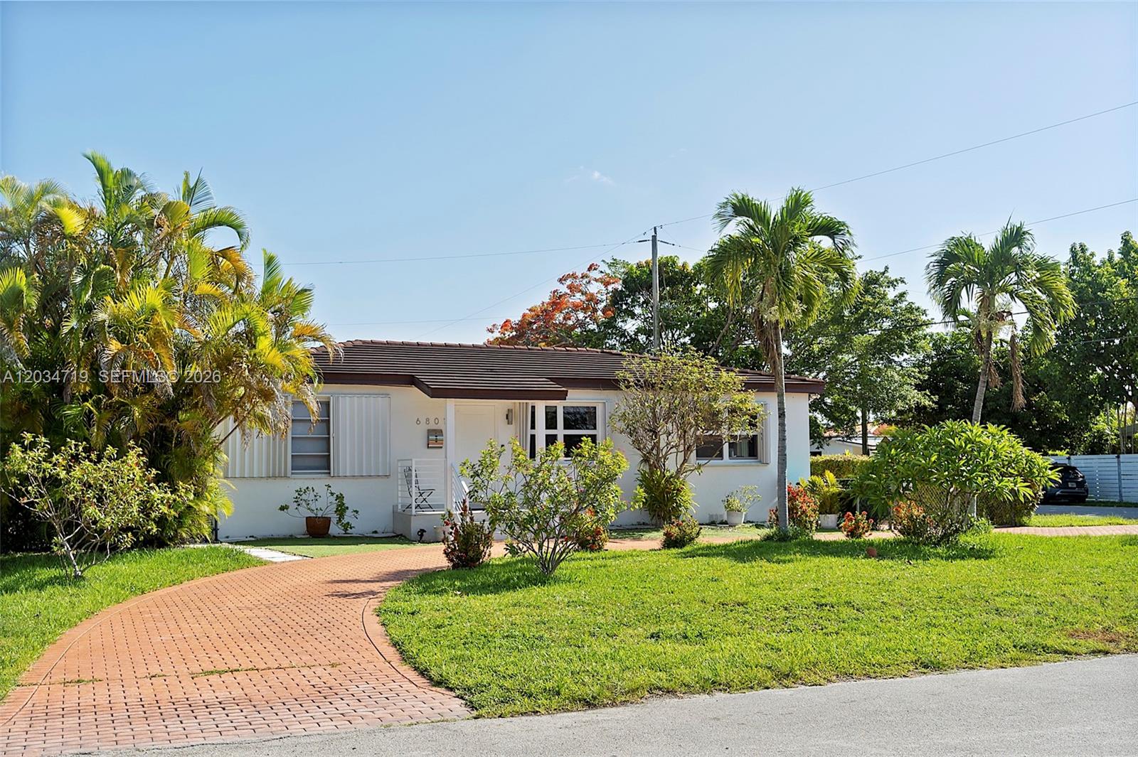 A single-story white house with a brick driveway and palm trees in the front yard — 6801 SW 27th St, Miami FL 33155, MIAMI, FL