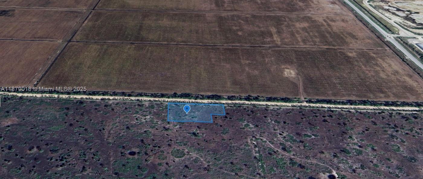 An aerial view shows a rectangular plot of land outlined in blue near a road — 0000 Del Verde, Punta Gorda FL 33982, PUNTA GORDA, FL