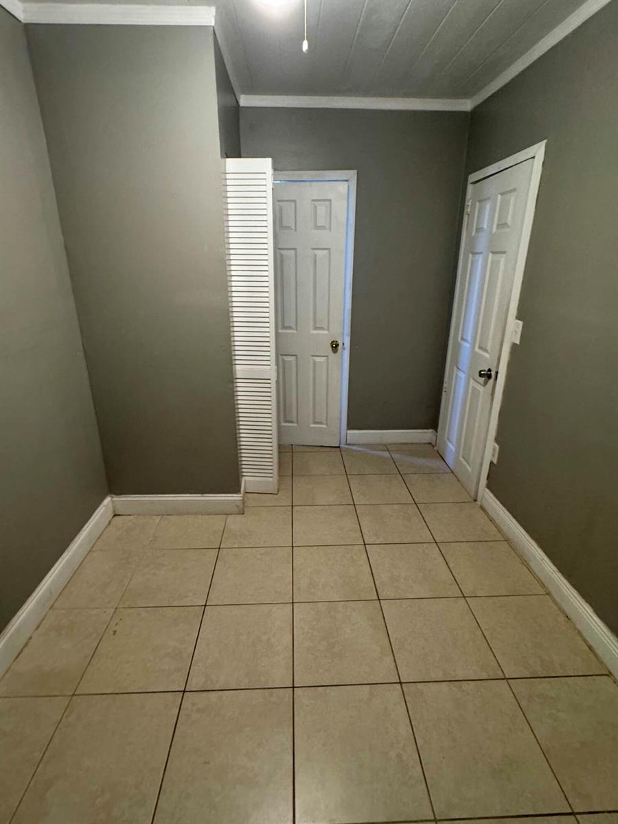 A small room with gray walls, tiled flooring, and two white interior doors — 717 S B Street # 715, FL 33460, FL