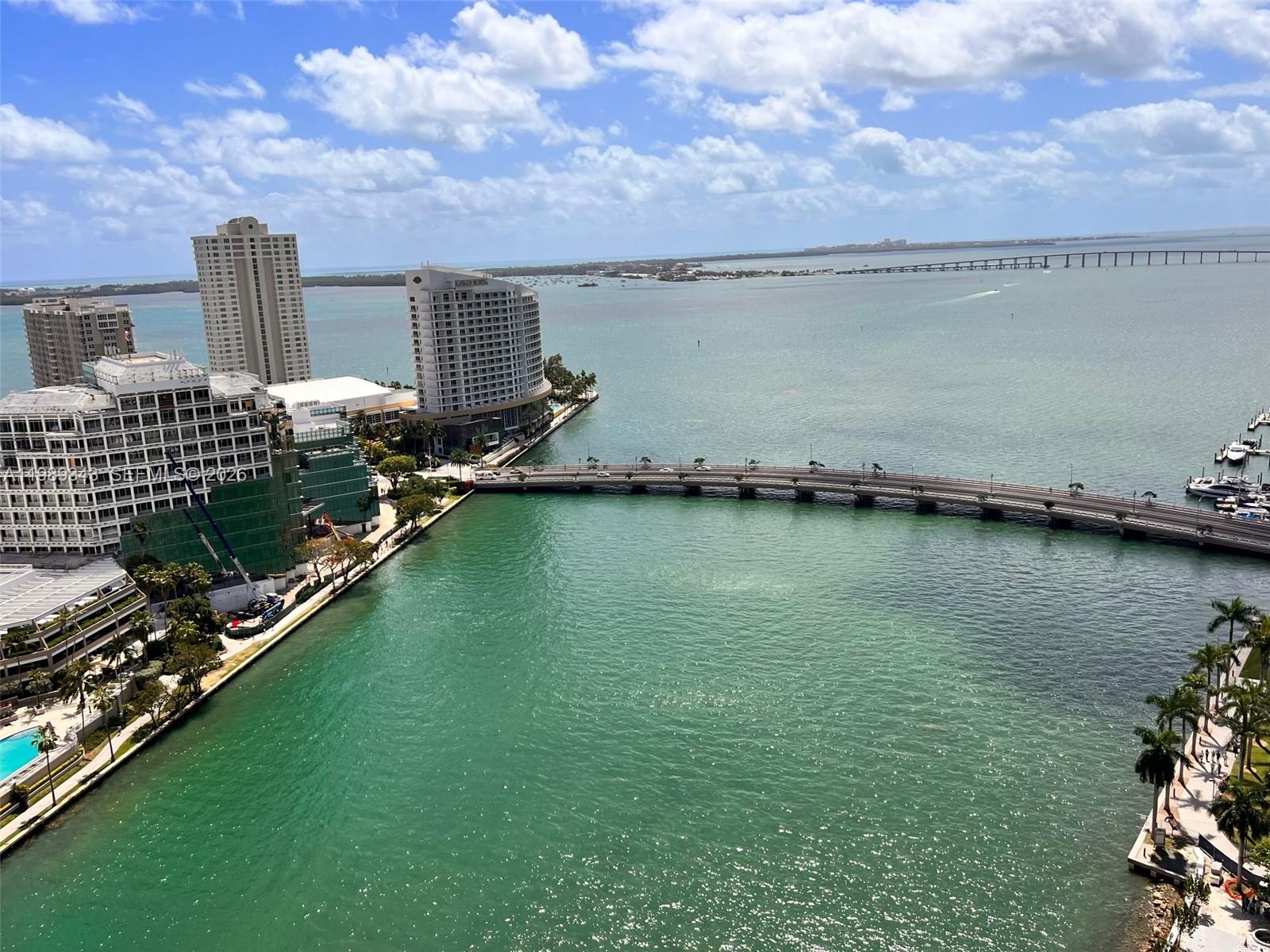An aerial view shows a bridge spanning a bay near high-rise buildings and boats — 495 Brickell Ave # 2401, Miami FL 33131, MIAMI, FL