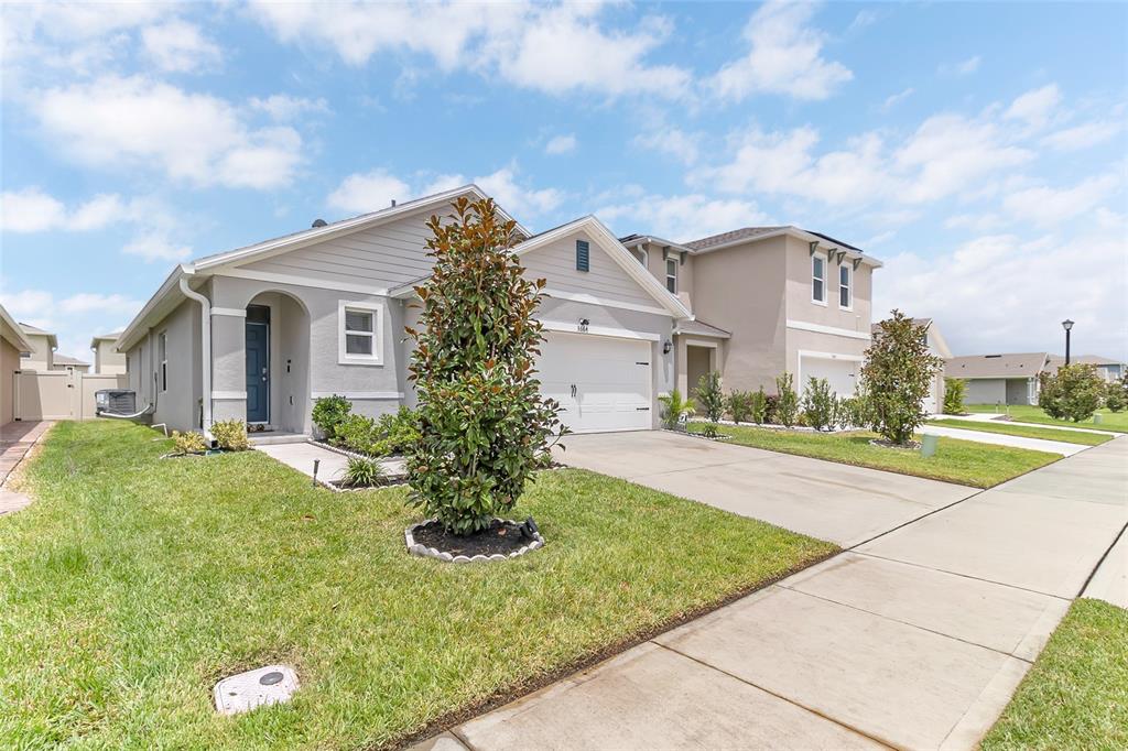 A single-story suburban house with a gray exterior, a two-car garage, and a front lawn — 3664 SUNGROVE CIRCLE, SANFORD, FL