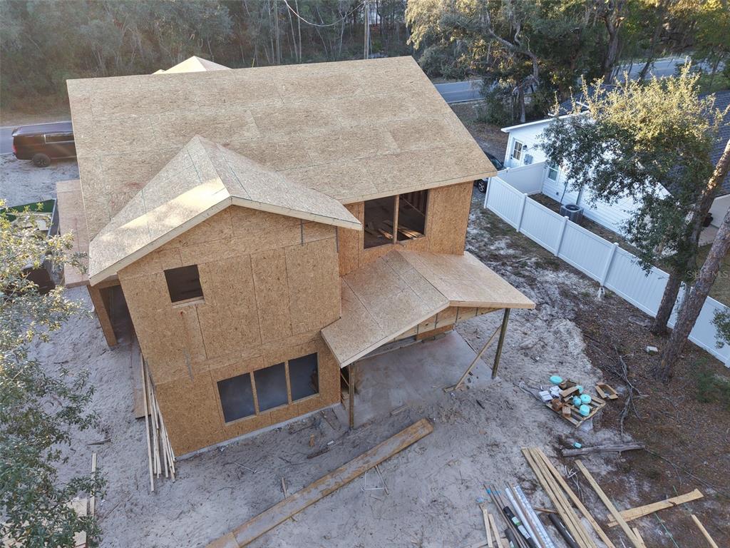 An aerial view of a two-story house under construction with exposed wooden sheathing — 228 DAWN AVENUE, INTERLACHEN, FL