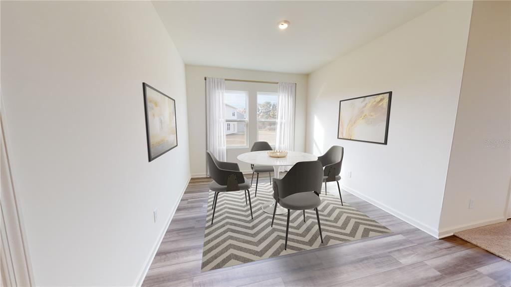 This is a digital rendering of a dining area with a table, chairs, and rug — 5555 BELDI DRIVE, POLK CITY, FL